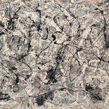A grey, black, and white abstract painting. There are no distinct figures or shapes, instead the paint is splattered randomly across the canvas.