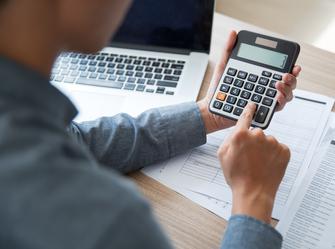 a man pressing buttons on a calculator
