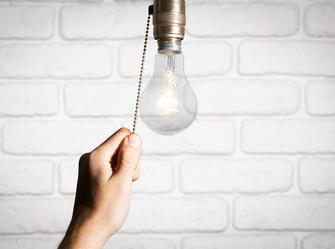 a woman turning on a lamp