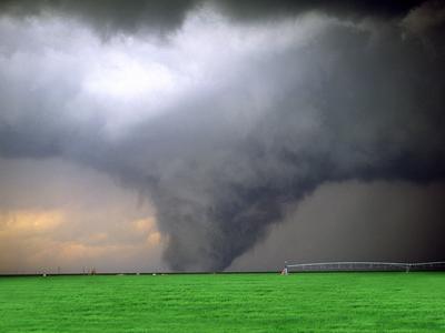 an image of a tornado passing through a field