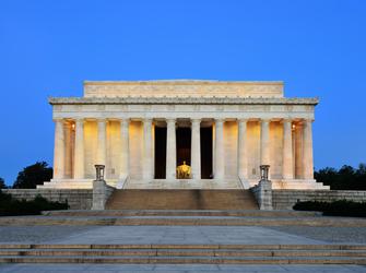 a large, white building with a statue of a seated man
