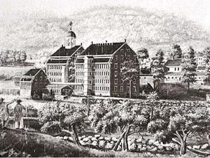 A large building alongside a river.