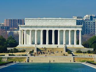 a large, white building with a statue of a seated man
