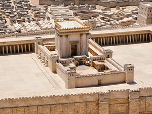 a model of a large and very old temple. It is made out of stone and has walls around it.