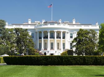 a large, white building with a semi-circle of columns where the President lives